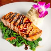 Grilled Salmon · Seared broccoli rabe and sun-dried tomatoes balsamic reduction.