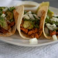 Tacos Al Pastor · Your choice of pork (original) or chicken. Served with rice, beans, lettuce, sour cream, gua...