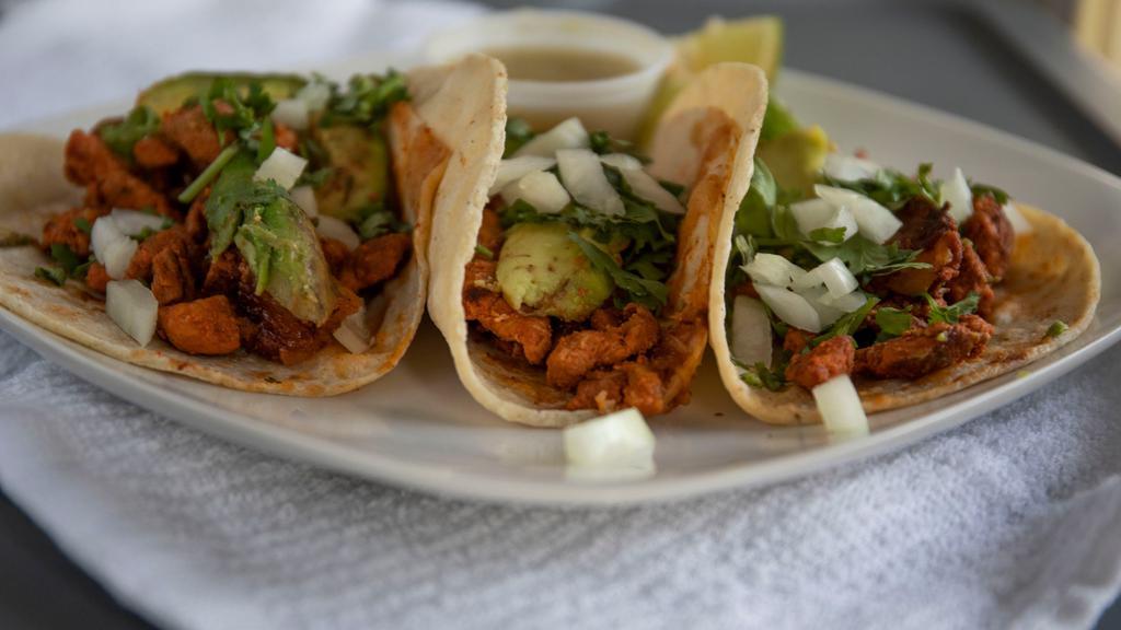 Tacos Al Pastor · Your choice of pork (original) or chicken. Served with rice, beans, lettuce, sour cream, guacamole and pico de gallo.