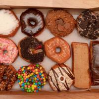 Half Gourmet Half Regular Dozen  · We pick a variety of our most popular and tasty donuts. Includes 6 Gourmet and 7 regular ass...