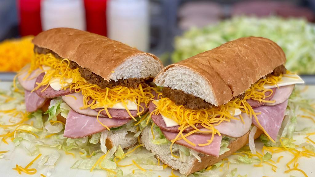 Everything Grinder - Whole · A 13 inch craft sub bun with our White Sauce, Lettuce, Hot Sauce, Ham, Turkey, Salami, Swiss Cheese, Colby Cheese & Taco Meat