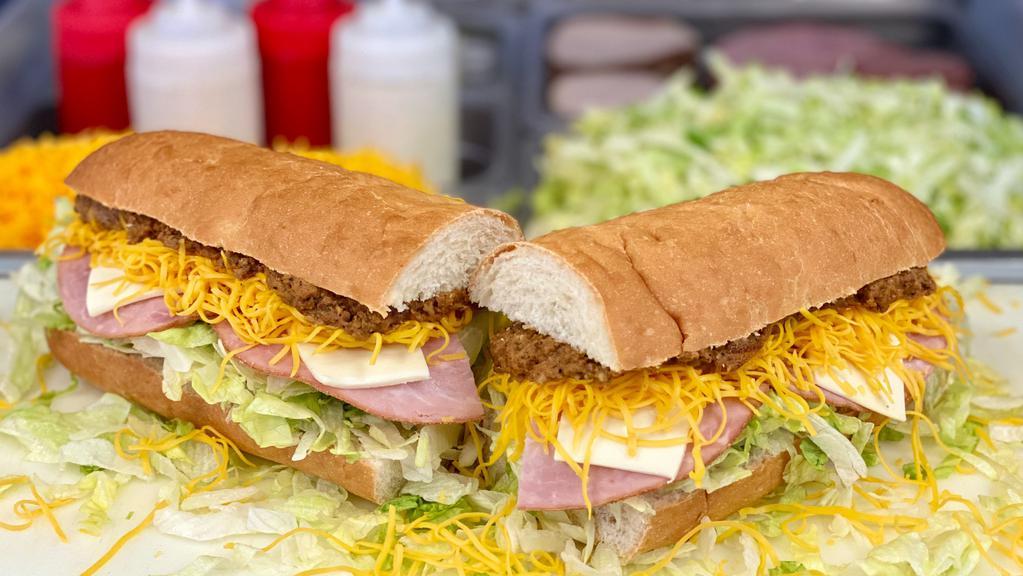 Ham Grinder - Whole · A 13 inch craft sub bun with our White Sauce, Lettuce, Hot Sauce, Ham and Swiss Cheese. Add Taco Meat & Colby Cheese to make it a real Grinder!