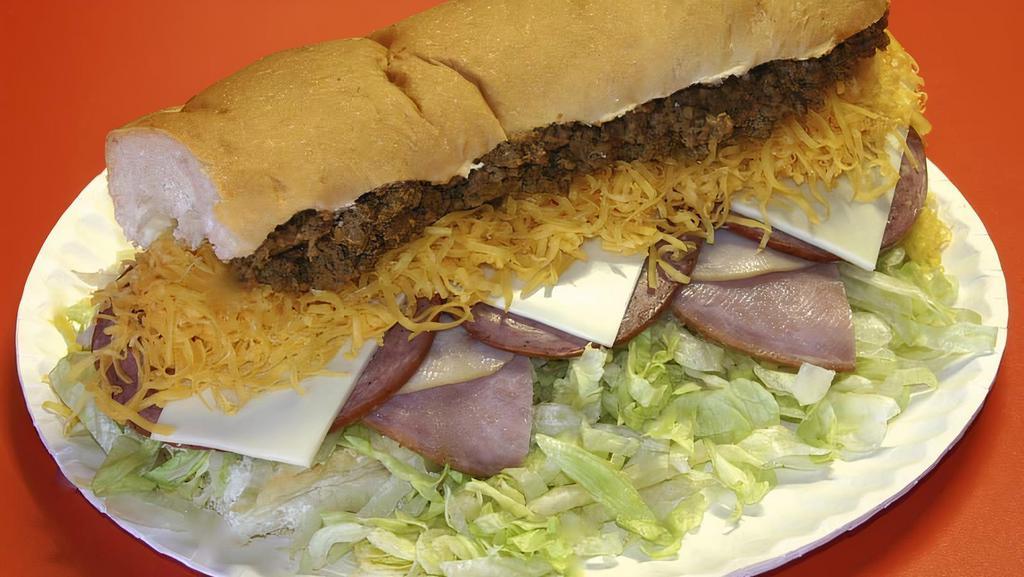 Everything Grinder - Half · A 6 inch craft sub bun with our White Sauce, Lettuce, Hot Sauce, Ham, Turkey, Salami, Swiss Cheese, Colby Cheese & Taco Meat