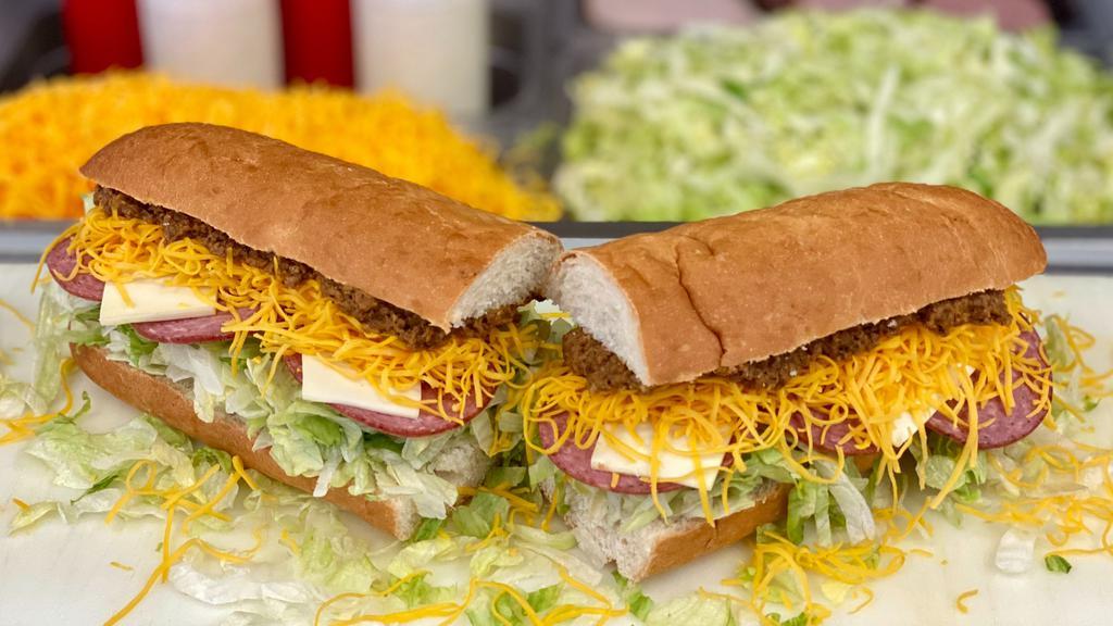 Salami Grinder - Whole · A 13 inch craft sub bun with our White Sauce, Lettuce, Hot Sauce, Salami and Swiss Cheese. Add Taco Meat & Colby Cheese to make it a real Grinder!