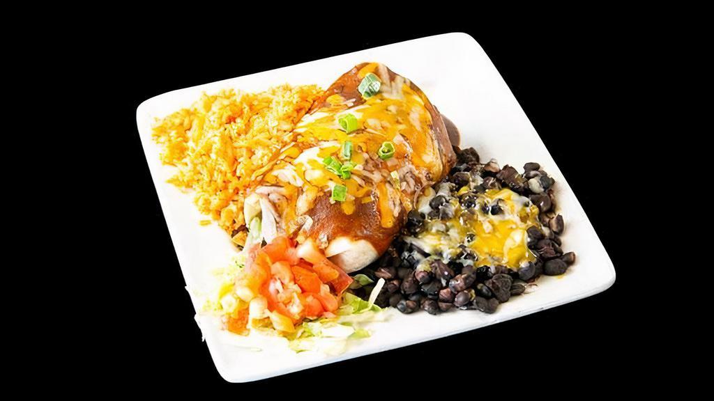 Taco Burrito · Beef, chicken, or pork, lettuce, tomato, green onion, cheese, enchilada sauce (served with black beans and rice)