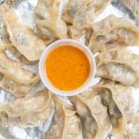 Steamed Chicken Momo · Steamed dumplings filled with ground meat, seasonal vegetables and Himalayan spices. (8 piec...