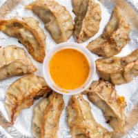 Kothey Chicken Momo · Pan fried Nepalese/Tibetan Momo (8 pieces per order).  Served with choice of Momo sauce - sp...