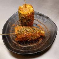 Japanese Street Corn · Sweet corn coated with Japanese mayo, furikake, and shichimi.