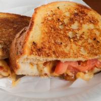 Deluxe Grilled Cheese · A mix of melted provolone, American and swiss cheese, bacon, and tomatoes. Served on grilled...