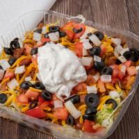 Taco Salad · Chili, cheese, tomatoes, black olives, onions on a bed of lettuce, and tortilla chips topped...