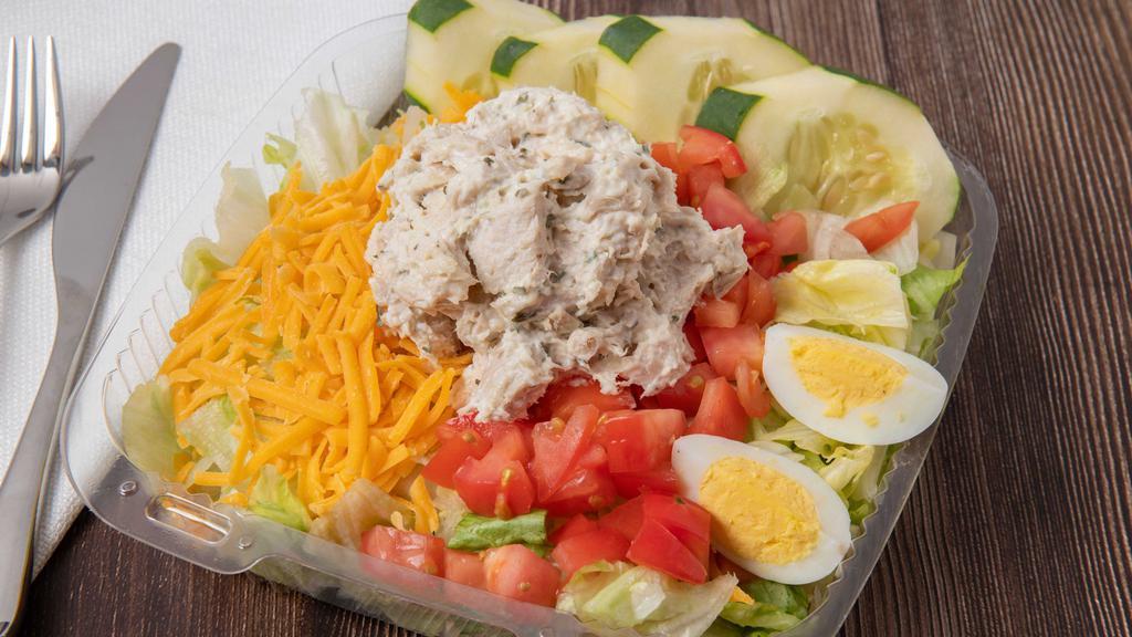 Chicken Salad Platter · A large scoop of chicken salad, greens with tomatoes, cheese, cucumbers, and hard boiled eggs.