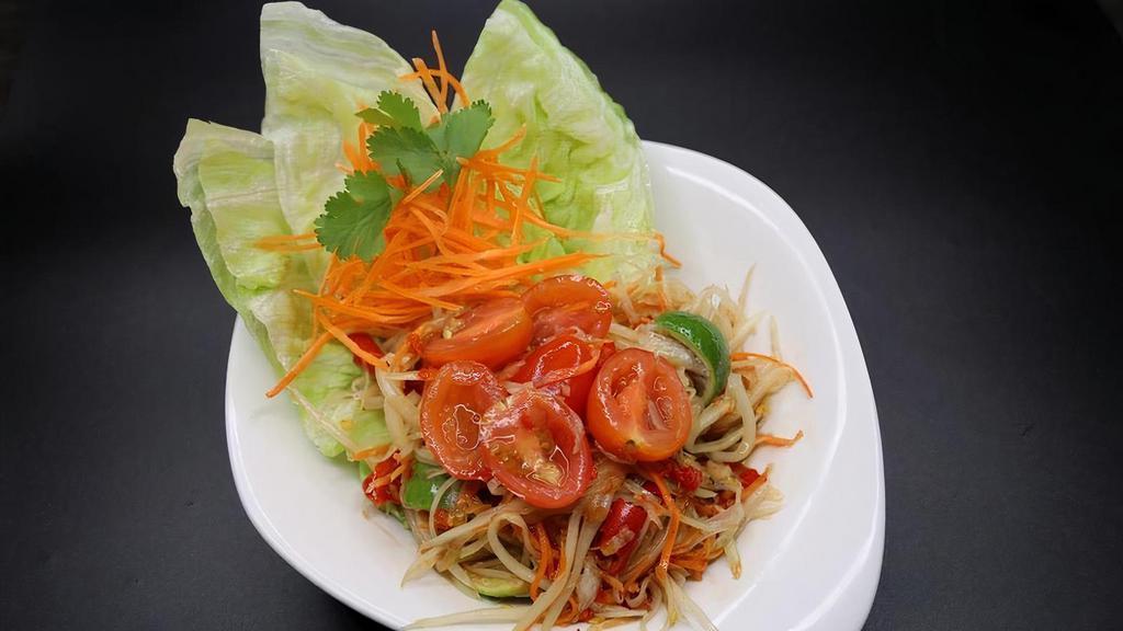 Som Tom Lao · FRESH GREEN PAPAYA SALAD, SHREDDED CARROTS AND CHERRY TOMATOES PREPARED IN A MIXTURE OF LIME JUICE, FRESH THAI CHILI, PALM SUGAR AND FERMENTED SEAFOOD PASTE.