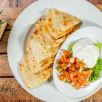 Quesadilla - Chicken · Two fresh flour tortillas stuffed with monterrey jack, cheddar cheese and chicken. Served wi...