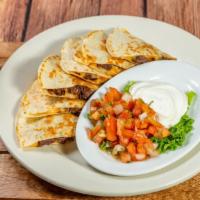 Quesadilla - Steak · Two fresh flour tortillas stuffed with monterrey jack, cheddar cheese and steak. Served with...
