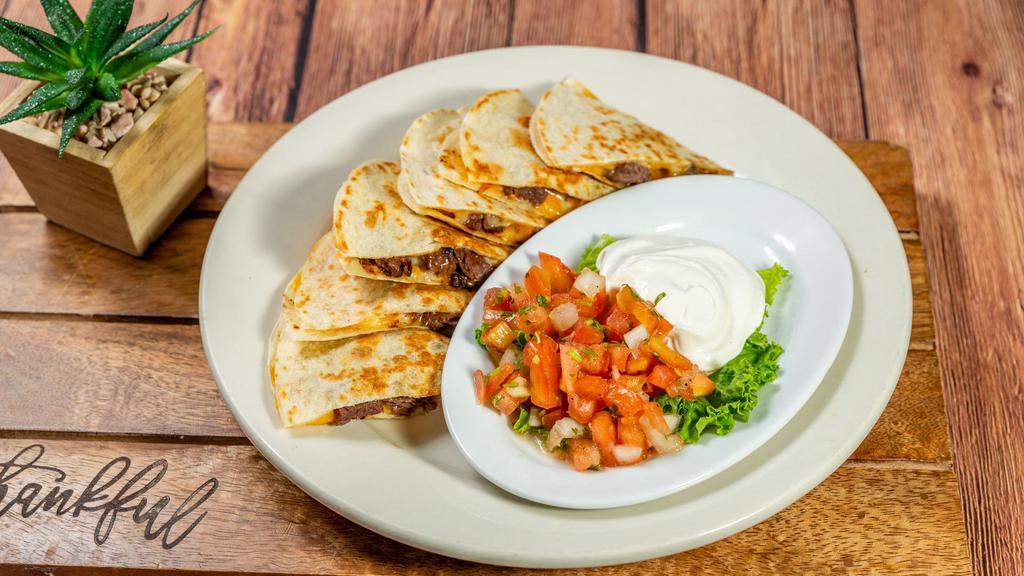 Quesadilla - Carnitas · Two fresh flour tortillas stuffed with monterrey jack, cheddar cheese and carnitas. Served with pico de gallo and sour cream.