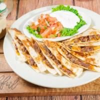 Quesadilla - Lamb · Two fresh flour tortillas stuffed with monterrey jack, cheddar cheese and lamb. Served with ...