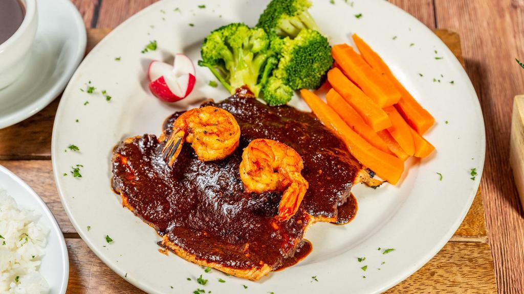 Pollo Al Mole · Grilled chicken breast, topped with shrimp and poblano mole sauce. Served with white rice, steamed veggies, and black beans on the side.