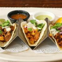 Tacos Al Pastor · Three soft corn tortillas filled with marinated grilled pork loin, onion, pineapple, and cil...