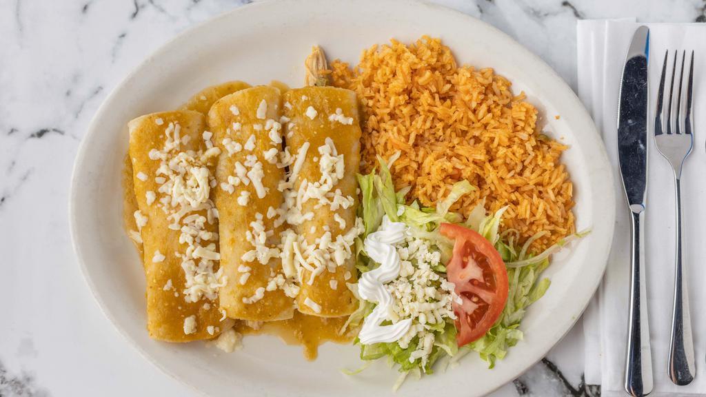 Enchiladas Verdes · (3) Green chile sauce topped enchiladas 1 beef, 1 chicken, one cheese, topped with lettuce, sour cream, tomatoes. Served with rice.