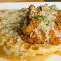 Chicken & Waffles · buttermilk waffle and crispy fried chicken. breast topped with signature sausage gravy with ...