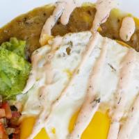 Huevos Rancheros · Crispy corn tortillas, two sunny side eggs, pork green chile, black bean puree, cheddar, avo...