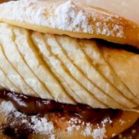Banana Nutella · Bananas and Nutella in a fried bao topped with powdered sugar.
