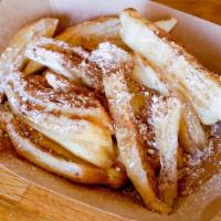 Beignet Bao Fingers · Fried bao fingers, cinnamon, and honey topped with powdered sugar.