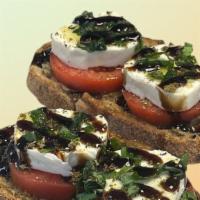 Genco Caprese Toast · Toasted Olive Bread, topped w/ Extra Virgin Olive Oil, Sliced Tomatoes, Fresh Mozzarella, Fr...