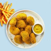 Chicken Nuggets · Bite sized nuggets of chicken breaded and fried until golden brown. (9 pieces).
