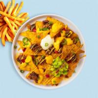 Loaded Nachos · Tortilla chips doused in chili, cheese, seasoned ground beef, black olives, tomato, onion, s...
