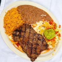 Carne Asada · A tender broiled eight oz steak, served with guacamole and a jack cheese enchilada topped wi...
