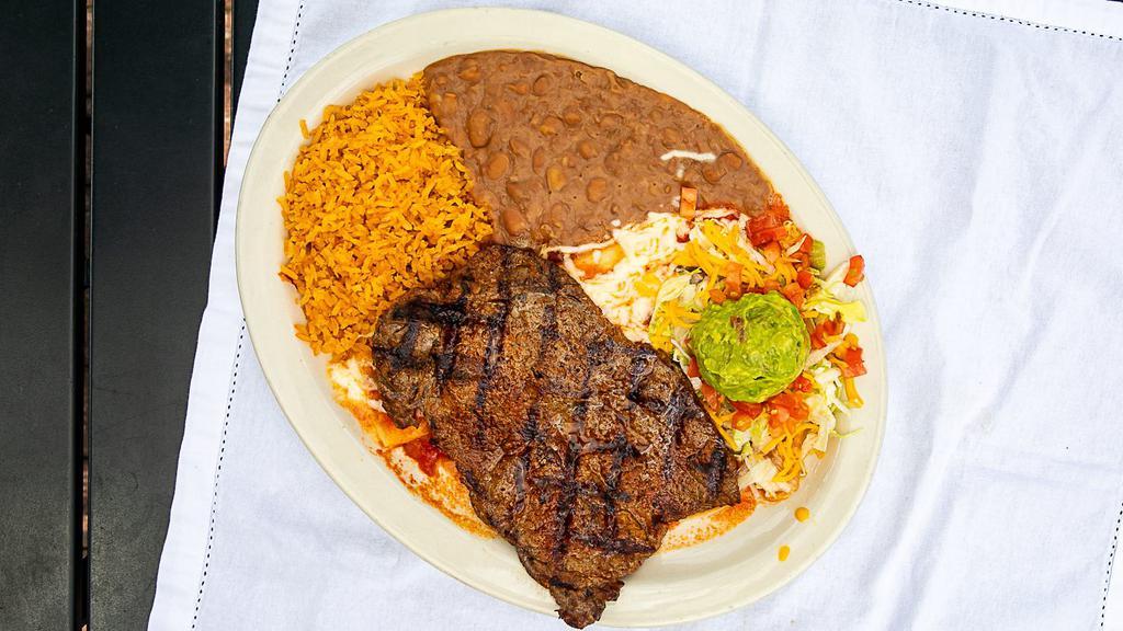 Carne Asada · A tender broiled eight oz steak, served with guacamole and a jack cheese enchilada topped with ranchero sauce.