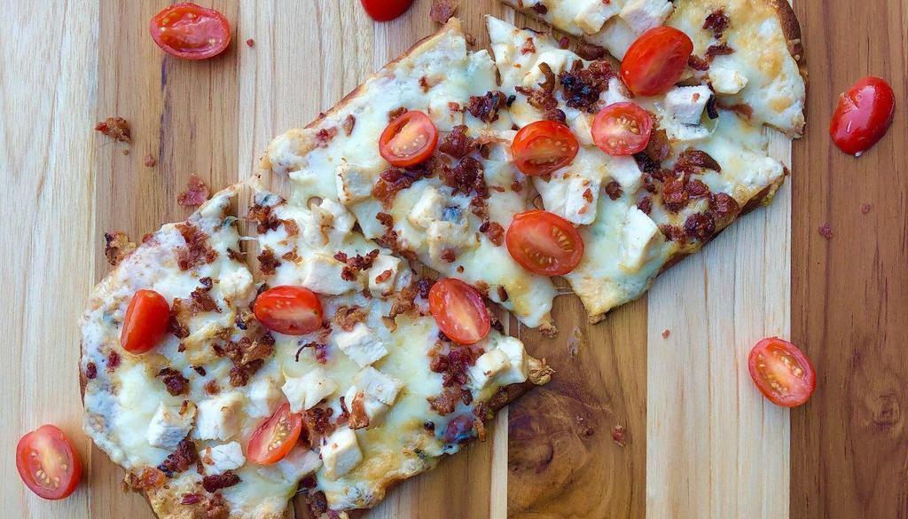Chicken, Bacon & Ranch Flatbread Pizza + Beverage & Chips · Chicken breast, applewood smoked bacon, cherry tomato, italian cheese blend and ranch spread. Served warm on a 12