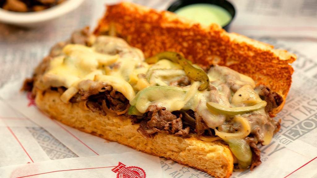 Philly Cheesesteak W Fries · Made the Philadelphia way! Fresh shaved Ribeye Steak topped with Grilled Peppers, Onions, and melted Provolone Cheese. 1110 cal.