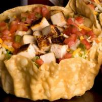 Southwest Chicken Taco Salad · Seasoned Grilled Chicken, Shredded Cheese, Fresh Guacamole, Sour Cream, Pico de Gallo, and T...