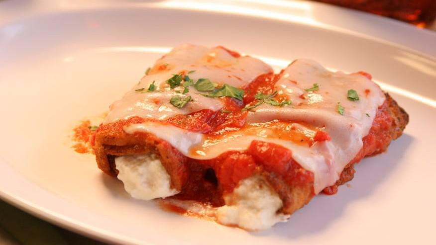 Eggplant Parmigiana · Homemade egg battered eggplant layered with marinara sauce and melted mozzarella served with a side of spaghetti. Comes with homemade roll.