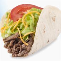 Soft Taco (Shredded Beef) · Seasoned slow cooked beef, mild real cheddar cheese, fresh lettuce and tomato in a warm flou...