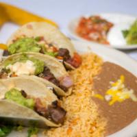 Tacos Oxaqueños · Three tacos with your choice of flour or corn tortillas filled with sautéed strips of steak,...