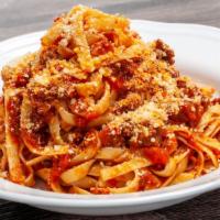 Tagliatelle With Bolognese · Home made ground beef, Red sauce Parmesan,  Basle, Garlic, Olive oil, salt and pepper.