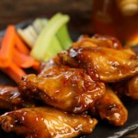 Traditional Hot Honey · 8 traditional wings tossed in hot honey (medium heat), served with carrots & celery and a di...