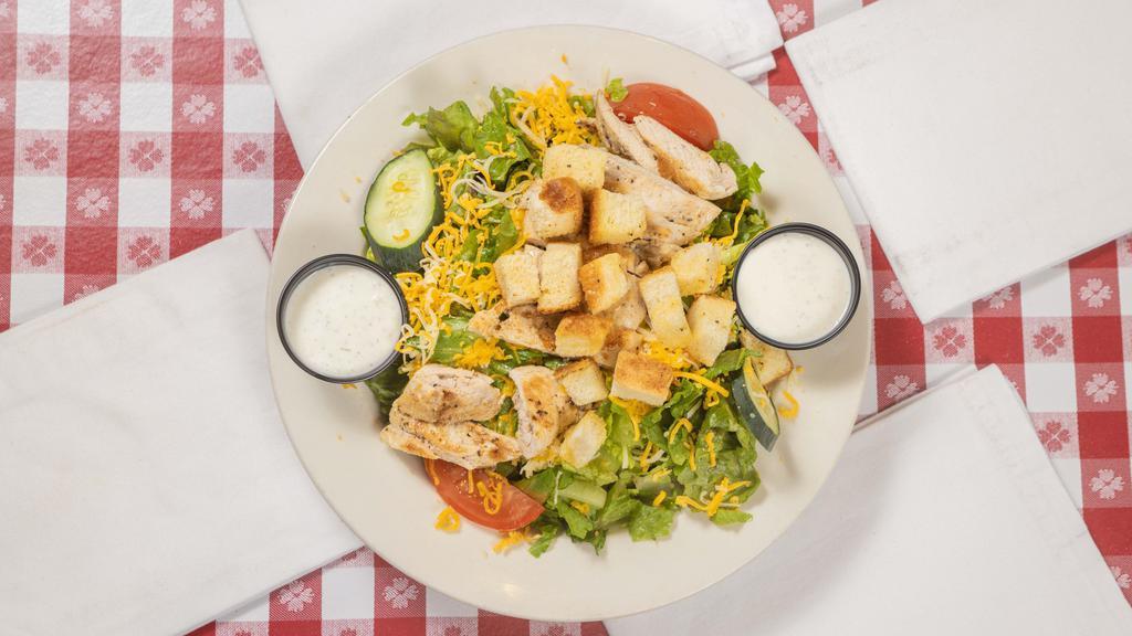 Grilled Chicken Salad · Strips of flavorful mesquite grilled chicken, served on crispy salad greens with Swiss and cheddar cheese, tomatoes, cucumbers and croutons.