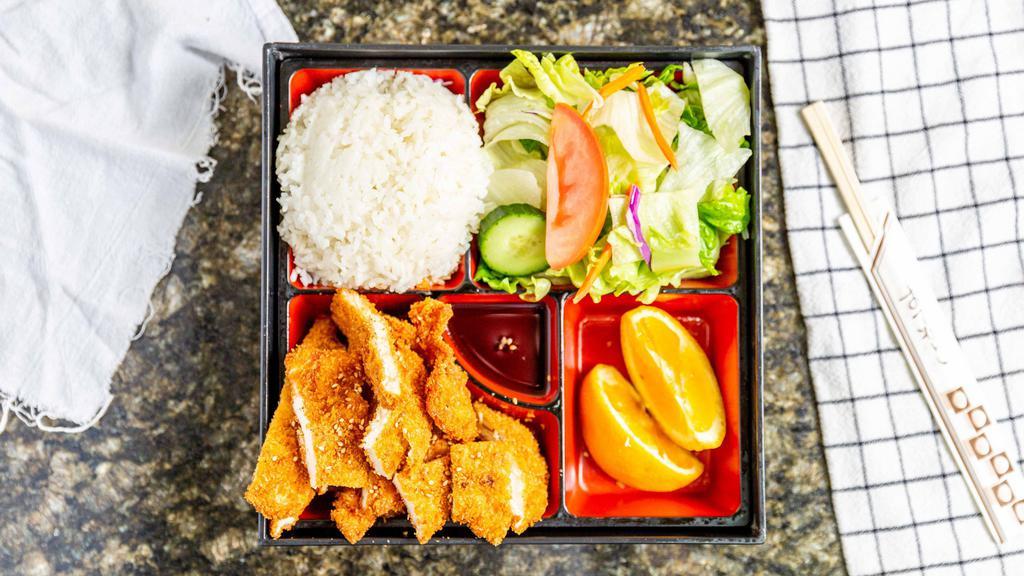 Sesame Chicken Bento Box · Deep fried chicken breast with rice, green salad, orange and teriyaki sauce.