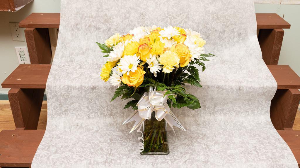 Golden Kiss · A kiss worth its gold, this bouquet comes with Roses Daisies, and some Leatherleaf, for a arrangement as passionate as your affection. (Vase Included.)