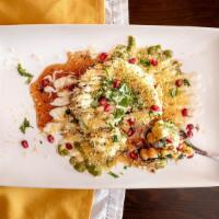 Aloo Papri Chaat · Wheat crisps, chickpeas, potatoes topped with yogurt, roasted cumin, mint and tamarind sauces.