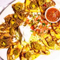 Nachos · Beef or chicken, black beans and mixed cheeses, served with sour cream.
