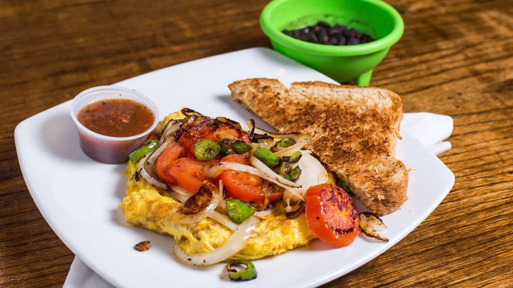 Tortilla Mexicana · Spicy. Scrambled eggs topped with sauteed onions, tomatoes, and jalapenos.