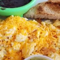 Migas · Scrambled eggs with tortilla chips and sauteed onions, topped with cheddar.