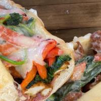 Italian Chicken Grinder · Italian breaded chicken tenders, sautéed spinach, roasted red peppers, prosciutto and sharp ...