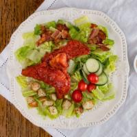 Where Buffalo Roam · Chopped Buffalo chicken tenders, bacon, tomato, cucumber, and croutons over romaine with ran...