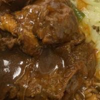 Brown Stew Chicken · Fall off the bone Jamaican brown chicken stew. Served with steam cabbage and rice and peas.